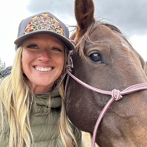 Chef Jaime Teigen in the field with a horse